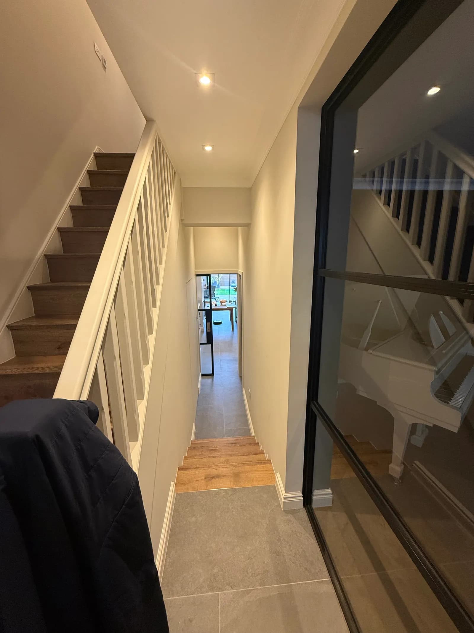 Staircase with a glazed screen in a refurbished home
